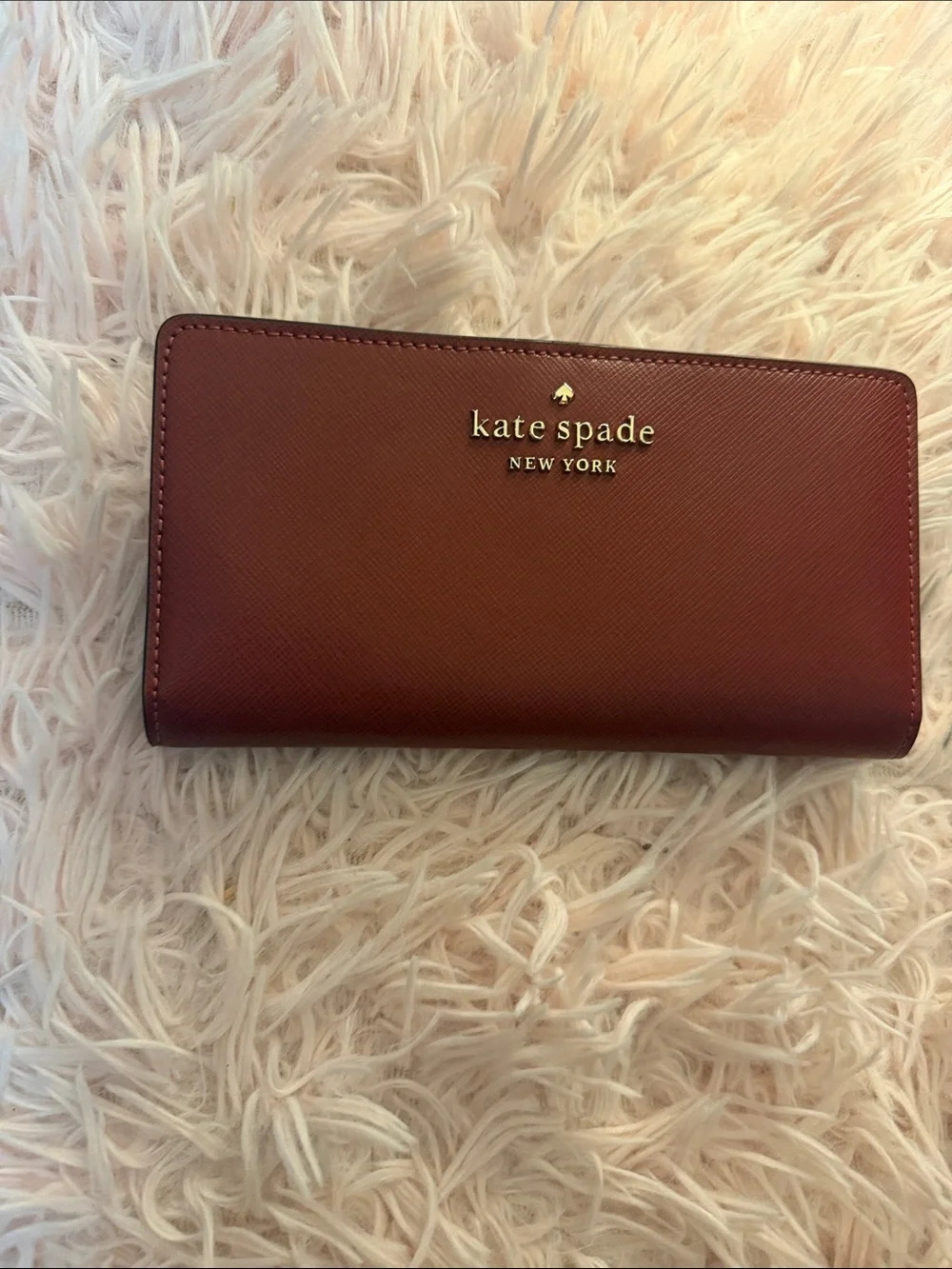 kate spade burgundy saffiano leather zip wallet with gold logo